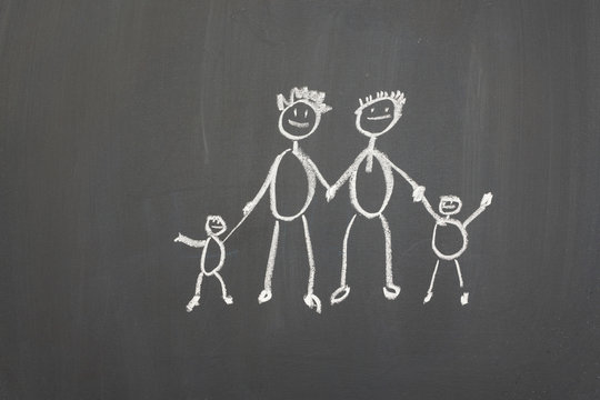 Blackboard with a child's drawing of a happy family