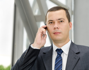 Portrait of young  businessman calling by telephone
