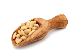 pine nuts in a wooden scoop