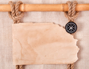 Compass, knot and old paper on the background of old cloth
