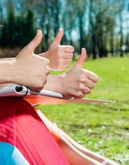 Students with thumbs up outdoors