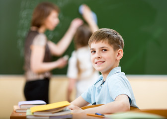 School boy in classroom at lesson
