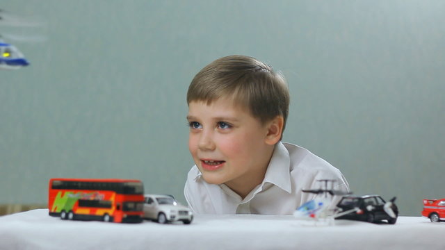 boy playing a toy helicopter