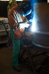 welder working at the factory - colorized photo