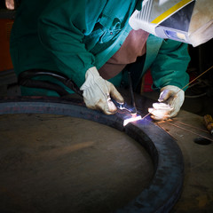 welder working at the factory - colorized photo