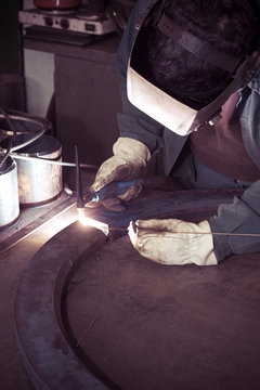 welder working at the factory - colorized photo