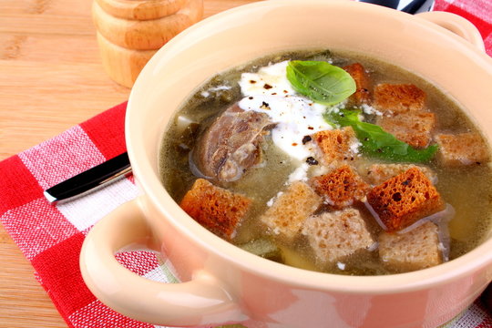 Green soup with meat, egg, croutons and cream