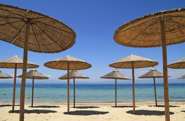 Straw umbrellas by the sea