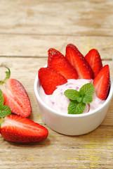 Strawberry yogurt with fresh fruits on wood background, dessert