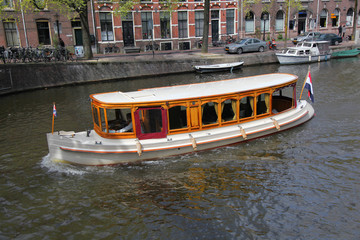 Fototapeta na wymiar City of Amsterdam with boat on canal in Holland