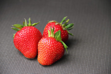 Fresh strawberry on dark grey background
