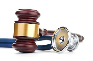 brown gavel and a medical stethoscope