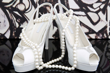 Wedding shoes with pearl necklace
