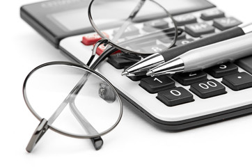 glasses and pen on calculator