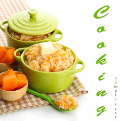 Taste rice porridge with pumpkin in saucepans, isolated