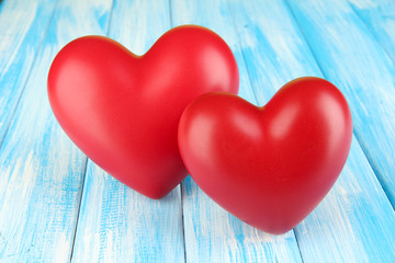 Decorative red hearts on color wooden background