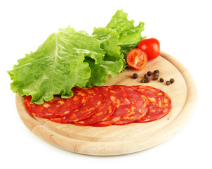 Salami slices on wooden board, isolated on white