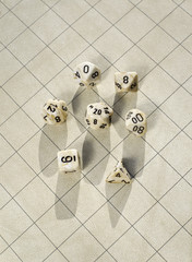 Polyhedral dice on blank square grid game map used in game