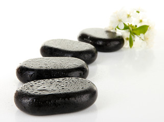Spa stones and white flowers isolated on white