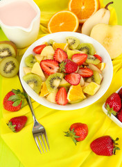 Useful fruit salad of fresh fruits and berries in bowl