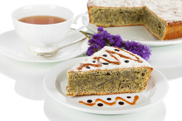 Delicious poppy seed cake with cup of tea isolated on white