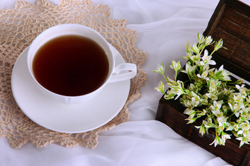 Composition with spring flowers and cup of tea
