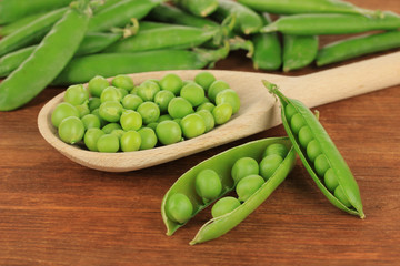Sweet green peas on wooden background