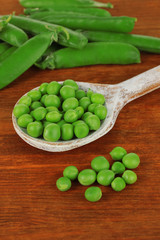 Sweet green peas on wooden background