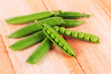 Sweet green peas on wooden background