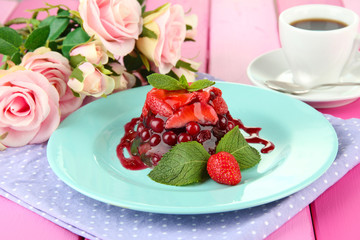 Tasty jelly dessert with fresh berries, on bright background