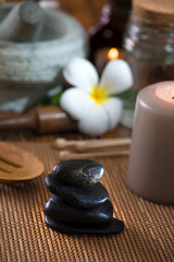 Fototapeta na wymiar hot stone massage with spa treatment items on the background