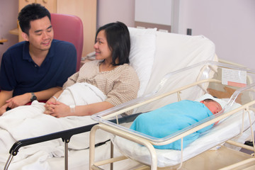 Asian newborn baby girl and daddy in hospital