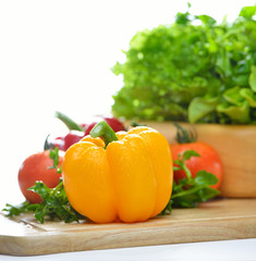 Yellow bell pepper on chopping block.