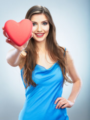 Heart, love symbol young happy woman hold. Isolated on studio b
