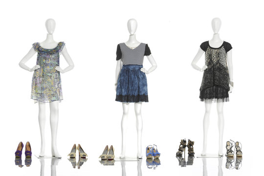 full-length female clothing with boots on three mannequin