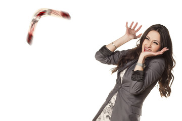 woman defending herself with her hands from the boomerang