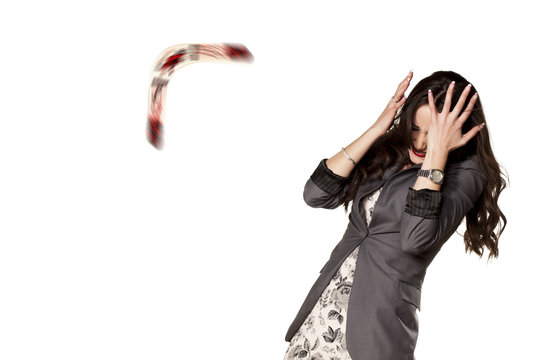 woman defending herself with her hands from the boomerang