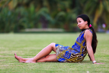 Asian woman sit on ground in park