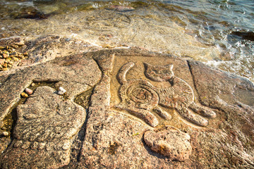 Rock carvings on the beach