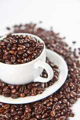 Cup with coffee beans, close up