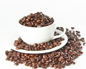 Cup with coffee beans, close up