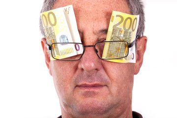 Man with banknotes behind the glasses