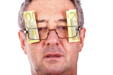 Man with banknotes behind the glasses