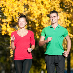 Young man and woman running