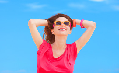 Redhead teen girl on blue sky background