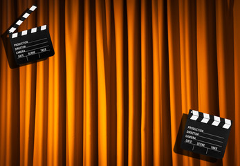 Movie clapper board against curtain
