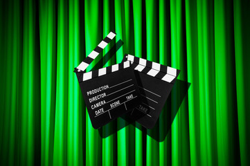 Movie clapper board against curtain