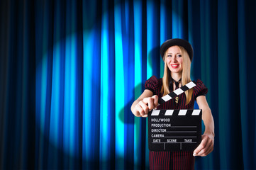 Woman gangster with movie clapper