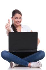 casual woman sits with laptop & ok