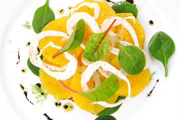 Fennel and orange citrus salad, on white plate.Raw, veg cuisine.